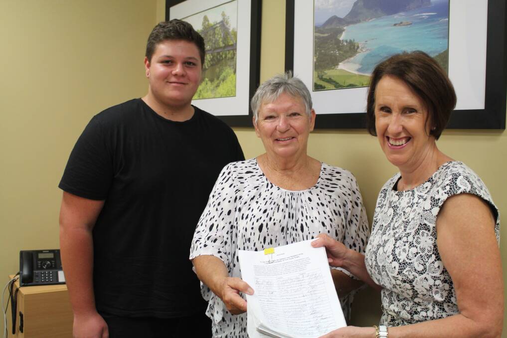 Petition: Member for Port Macquarie Leslie Williams with Rhonda Taylor and Kyle Hardes and the petition calling for the overpass at the Harrington/Coopernook intersection of the Pacific Highway to be built.