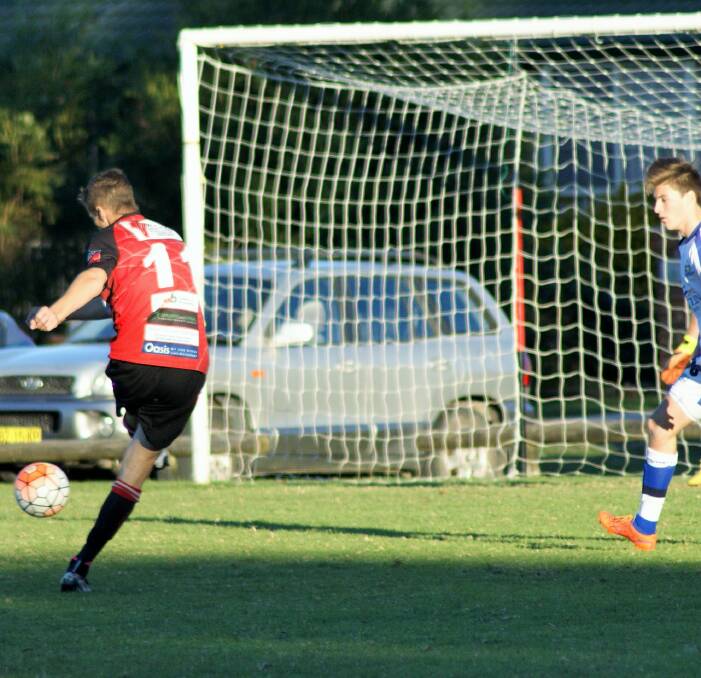 Shot on goal: Jeremy Robinson slots home the 2nd goal for Redbacks. Pic: Luisa Papas