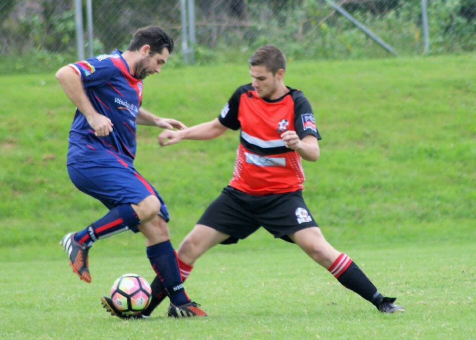 Tussle: Camden Haven Redbacks' Riley Papas battling with a Wauchope Soccer Club opponent during their round 1 clash. The Redbacks will enjoy the bye this weekend.