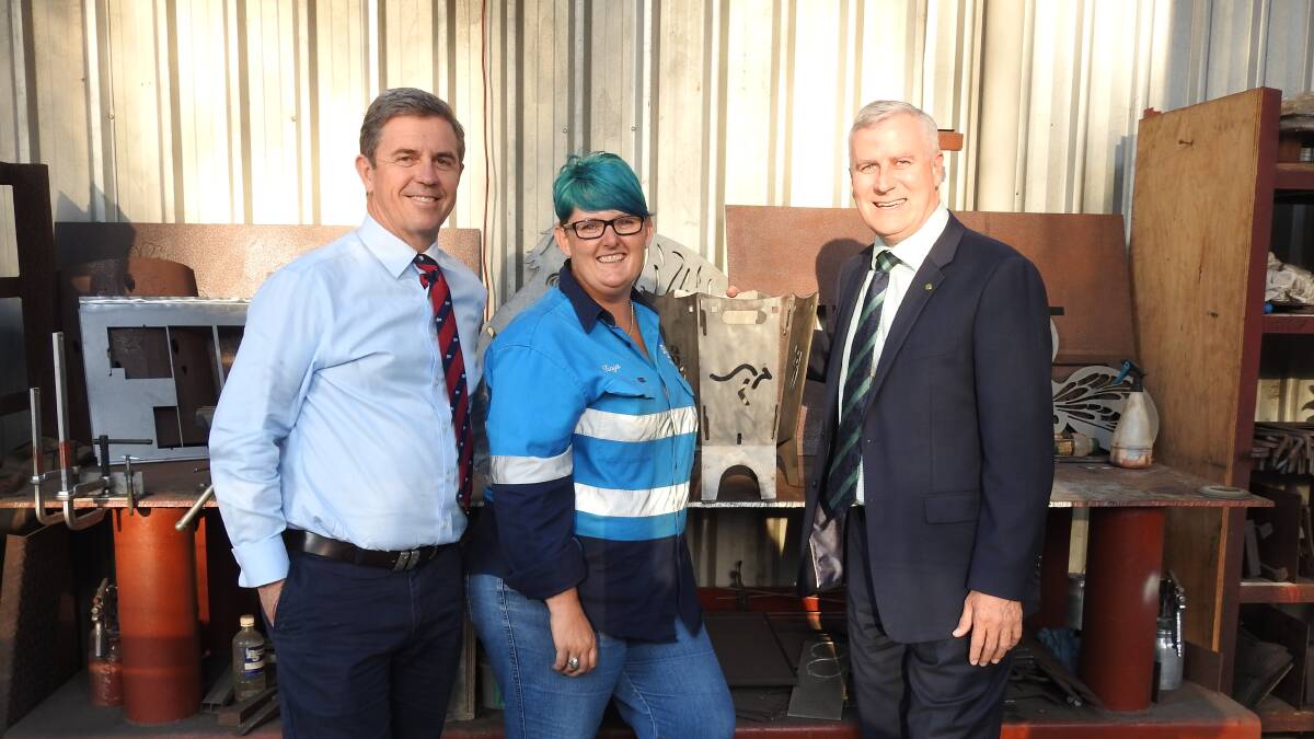 TAX CUTS ON THE WAY: Minister David Gillespie and Michael McCormack with Tanya Simmons from Bennetts Steel in Wauchope with a flatpack fireplace they sell to grey nomads.