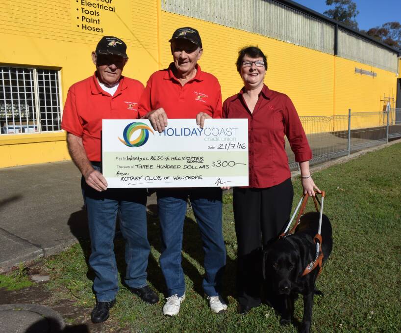 An inspiration:  Kathryn Stephens, the new Rotary Club of Wauchope president, and her guide dog, Gulliver donate $300 to Westpac Rescue Helicopter support group's John Smith and Bruce Cant.