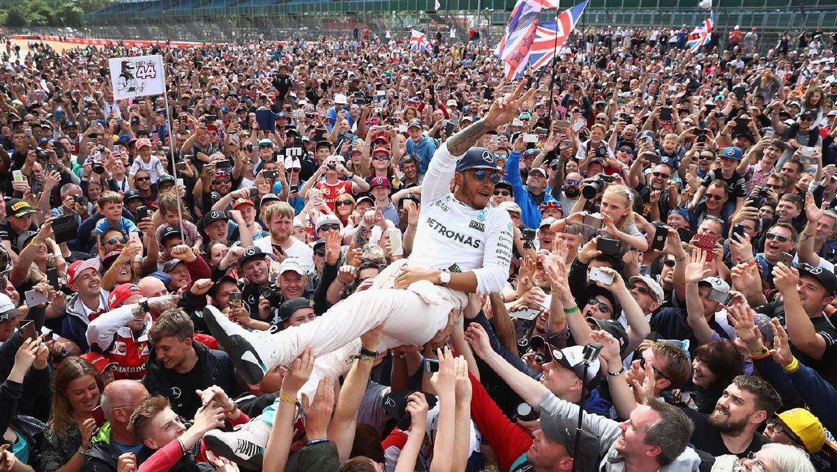Lewis Hamilton of Great Britain and Mercedes GP crowd surfs with the fans to celebrate his win during the Formula One Grand Prix of Great Britain at Silverstone on July 10, 2016 in Northampton, England. Photo: Clive Mason/Getty Images
