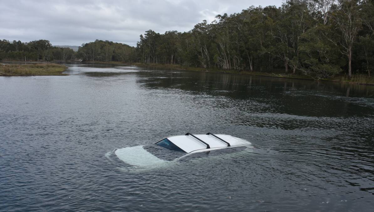 Driver safe: A vehicle landed in the water at Lake Cathie after a driver had a run in with a huntsman at about 10am on Tuesday, November 1, 2016.