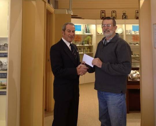 Contribution: The Freemasons Lodge of Laurieton secretary Walter Schelleuberg hands over the $250 cheque to the Camden Haven Historical Society’s president Phillip Bowman in the museum.