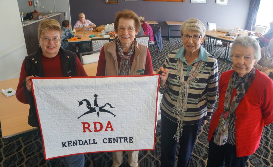 Lovely surprise:  RDA Kendall branch president Elizabeth Wallace with LUSC Friendship Quilters secretary Barbara Booth, president Yvon Buxton and assistant secretary Jean Hodge. 