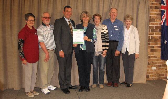 Celebration: Nola Morgan, Ross Morgan, George Hoad, Frances Hoad, Barbara Jackson, Ian Jackson and Kathy Green. Newly elected committee of Midcoast Garden Friends receive certificate of congratulations for their 10th birthday from George Hoad, President of Garden Clubs of Australia.
