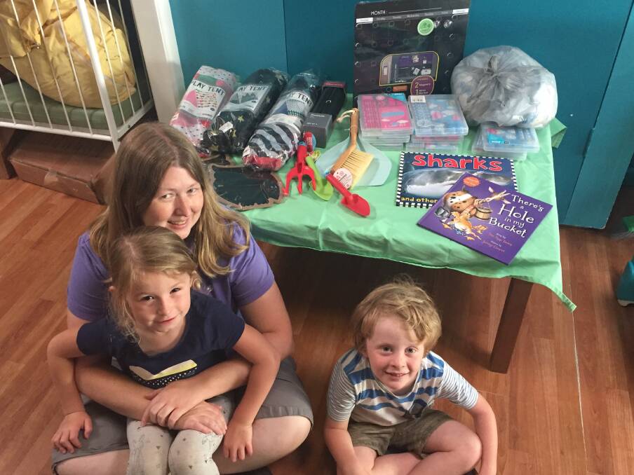 Christmas appeal: Laurieton Early Education Centre is accepting donations in the form of gifts and non perishable food items to donate to others less fortunate. Julie Davis pictured with children Kiera Ansell and Toby Ewan. 