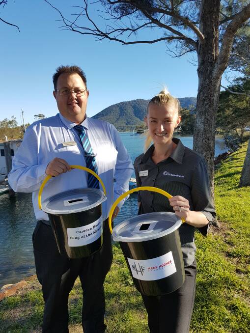 Helping the cause: 2iC Shane Globits and Club North Haven staff member Eve Gillbanks with donation buckets.