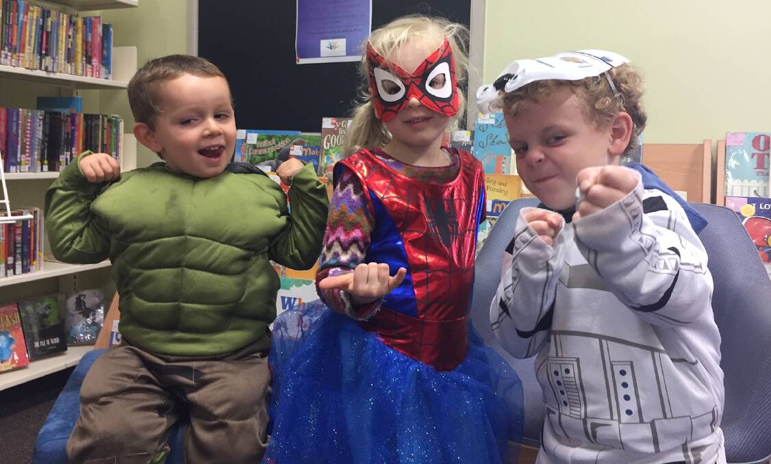 Bam, pow: Jeremy Thompson as The Hulk, Gemma Fowler as Spidergirl and Sonny Stapleton as a Stormtrooper keep it superhero real during storytime at Laurieton library.