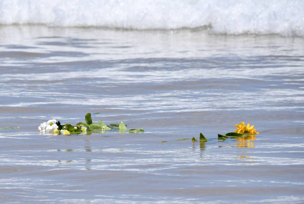 Tragic: Flowers were sent out to sea to honour the little boy's life. Photo: Ivan Sajko.