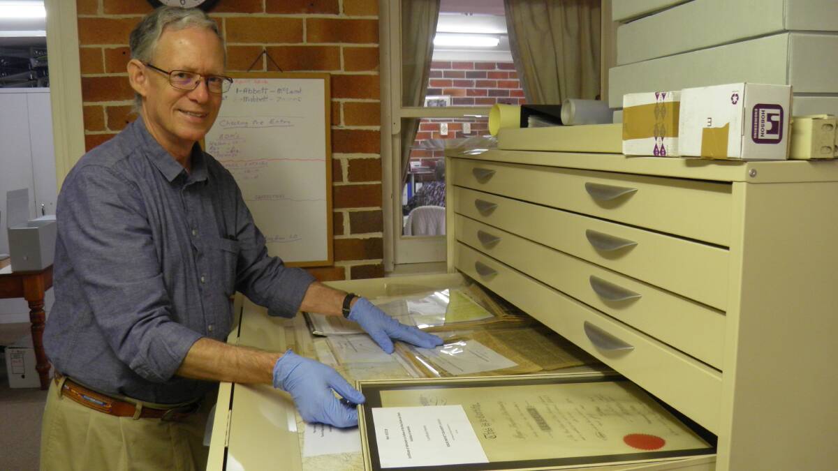 Preserving history: Clive Smith reviews some of Roger Dulhunty's documents and records, now held in the Port Macquarie Museum's archives.