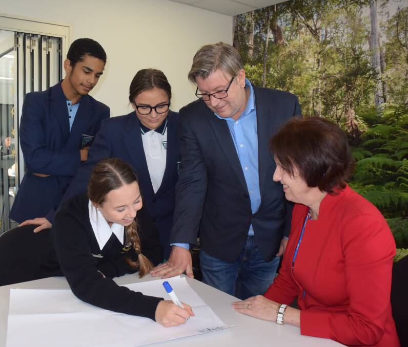 Youth feedback: MacKillop College student Lily Burgmann (front left) gets ready to write down youth priorities with input from Camden Haven High School students Hamish Cook-Webber and Xanthia Hughes as NSW advocate for children and young people Andrew Johnson and Port Macquarie MP Leslie Williams look on.