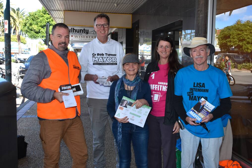 Democratic process: Jeff Forster, Rob Turner, Robyn Marshall, Sharon Griffiths and Stephen Cartwright hand out how to vote material outside the Port Macquarie pre-poll centre.