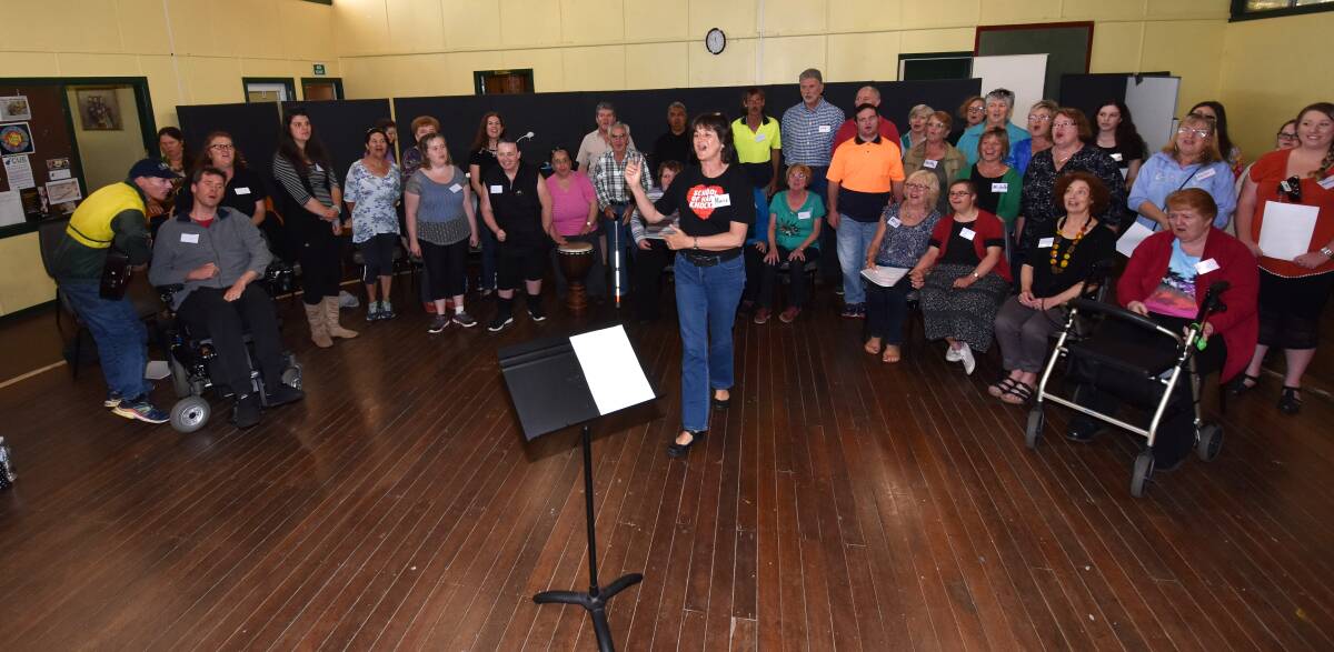 Inspirational: Choir director Marie van Gend instructs the Absolutely Everybody Choir Port Macquarie Hastings School of Hard Knocks.