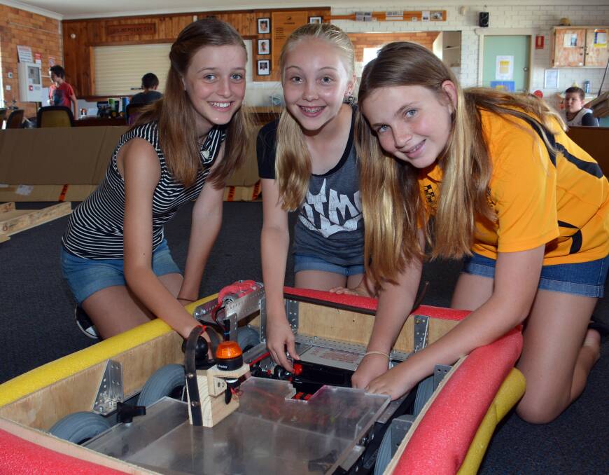 Showing the way: Elizabeth Legge, Ebony Nicholas and Alisha Cooper practise with the Megabot they hope will help the Camden Haven High School team bring home the First Robotics Competition rookie prize. Photos PETER GLEESON