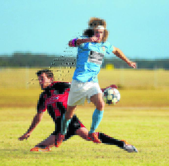 On the charge: Matt Ramm leaps a Camden Haven opponent on Saturday. He scored for FC in a 2-2 draw.  
Pic: MATT McLENNAN