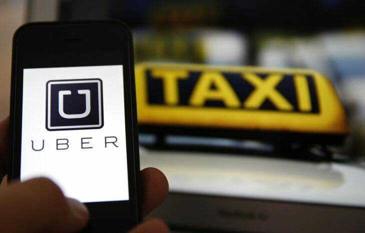 An illustration picture shows the logo of car-sharing service app Uber on a smartphone next to the picture of an official German taxi sign in Frankfurt, September 15, 2014. A Frankfurt high court will hold a hearing on a recent lawsuit brought against Uberpop by Taxi Deutschland on Tuesday.  San Francisco-based Uber, which allows users to summon taxi-like services on their smartphones, offers two main services, Uber, its classic low-cost, limousine pick-up service, and Uberpop, a newer ride-sharing service, which connects private drivers to passengers - an established practice in Germany that nonetheless operates in a legal grey area of rules governing commercial transportation. The company has faced regulatory scrutiny and court injunctions from its early days, even as it has expanded rapidly into roughly 150 cities around the world.   REUTERS/Kai Pfaffenbach (GERMANY - Tags: BUSINESS EMPLOYMENT CRIME LAW TRANSPORT)

AFR 19-12-2014