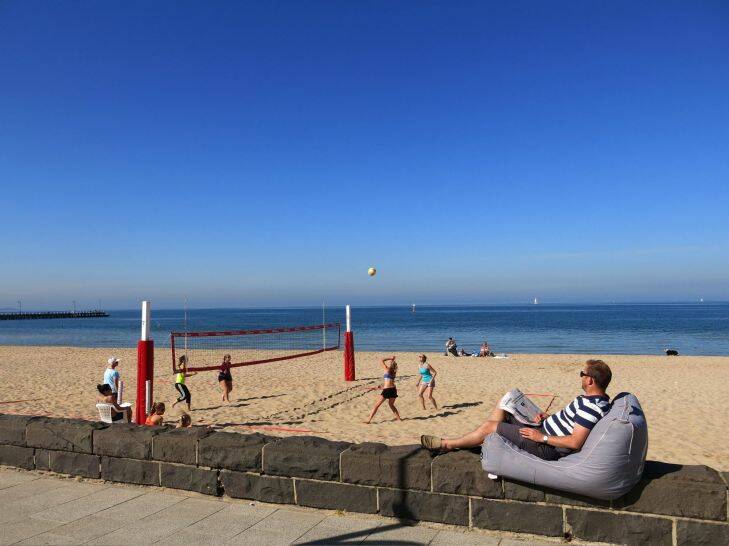 Pic Leigh Henningham for the Age Ipad. 2014 Port Phillip Bay Scenes.  A lazy man watches volley ball at Middle Park beach.             a