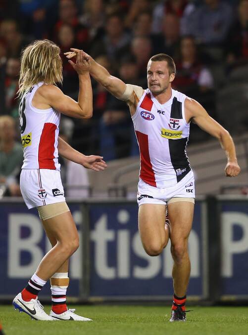 Jarryn Geary of the Saints is congratulated by Eli Templeton after kicking a goal during the round five AFL match between the Essendon Bombers and the St Kilda Saints at Etihad Stadium on April 19, 2014 in Melbourne, Australia. Photo: Quinn Rooney/Getty Images.