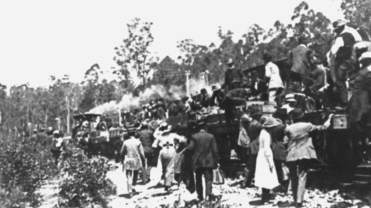 All aboard:  A crowd boards the first train from Taree to Kendall at Ross Glen Station in 1914.