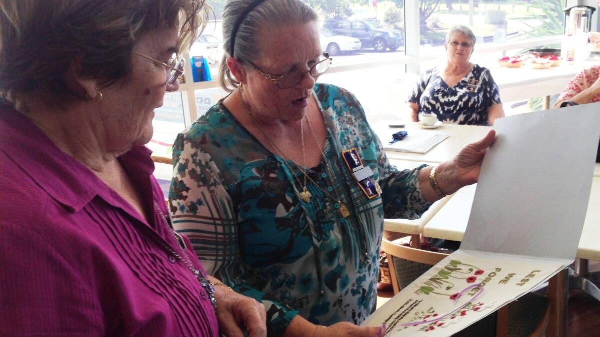 Helen Keevers reacts to seeing the LUSC Friendship Quilters' block for the Lest We Forget quilt.