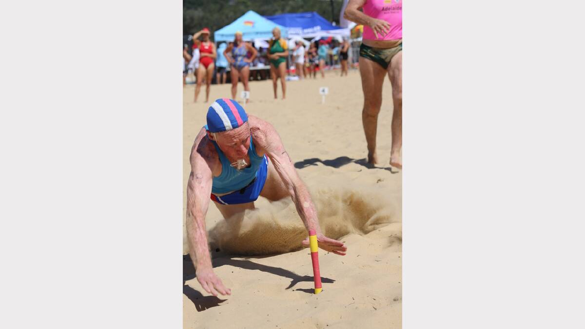 IN ACTION: 78 year old surf lifesaving veteran George Fowler lunges for the flag. Photo: SLSNSW.
