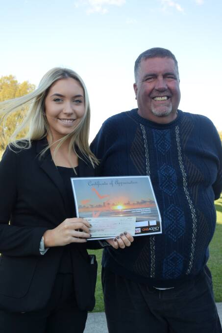 ONE LOCAL HERO: Cherish Hobman presents Graham Lee with the award and donation at the barbecue on Friday.