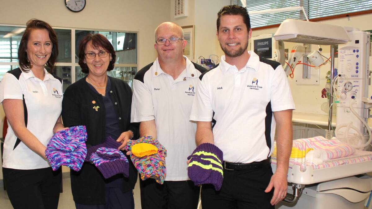 CUDDLY DONATIONS: Midwife Julie Vegter with Rotary e-Club of Next Gen members Jackie Jones, President Peter Saville and Nick Jones.