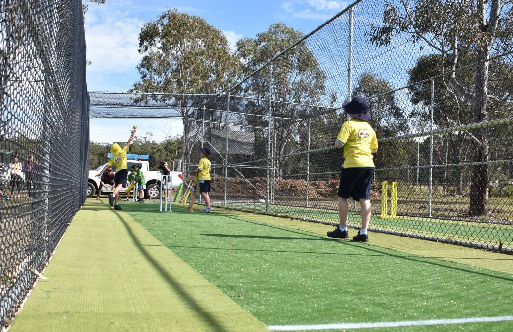 On the ball: Some students from Lake Cathie Public School playing on the new cricket nets.