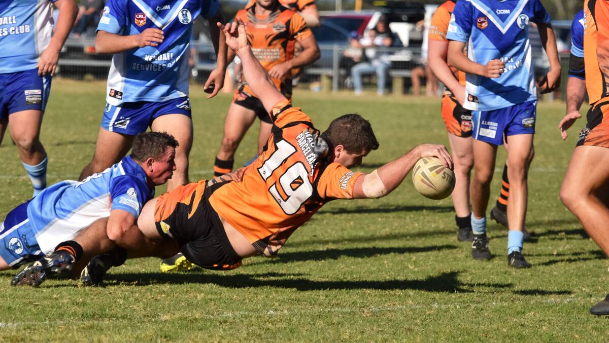 Try time: Comboyne Tigers interchange Brendon Slade slams the ball over the line against the Kendall Blues on Saturday. Photo: Ivan Sajko