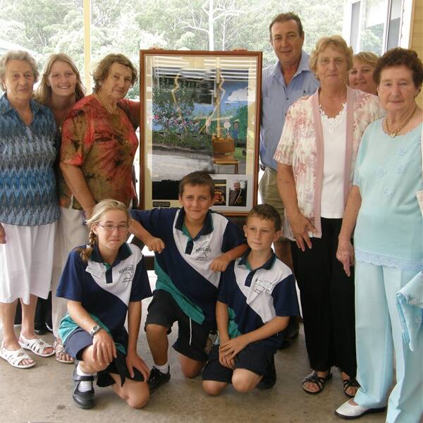 History comes home: The late Keith Stace’s football blazer was presented to Herons Creek Public School earlier this month. Pic standing (L to R) are Joan Fletcher, Kirsty Appleby, Audrey Stace, Geoff Stace, Kaye Knight, Kim Appleby and Daphne Marchant with school captains Hannah Morson, Harry Bean and Jacob Asquith.