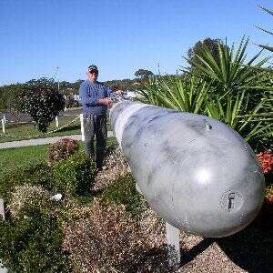 Work in progress: RSL Sub Branch member Doug Browne works on the torpedo, a new feature in the grounds of the Laurieton United Services Club.
