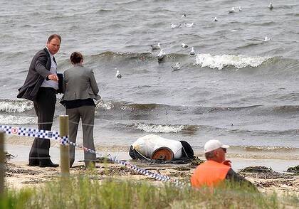 Police examine a suspicious package, possibly a body, at Kyeemagh, south of Sydney Airport.
