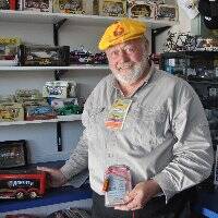 Will Hagon surrounded by some of his beloved motorsport memorabilia at Kew Pit Stop