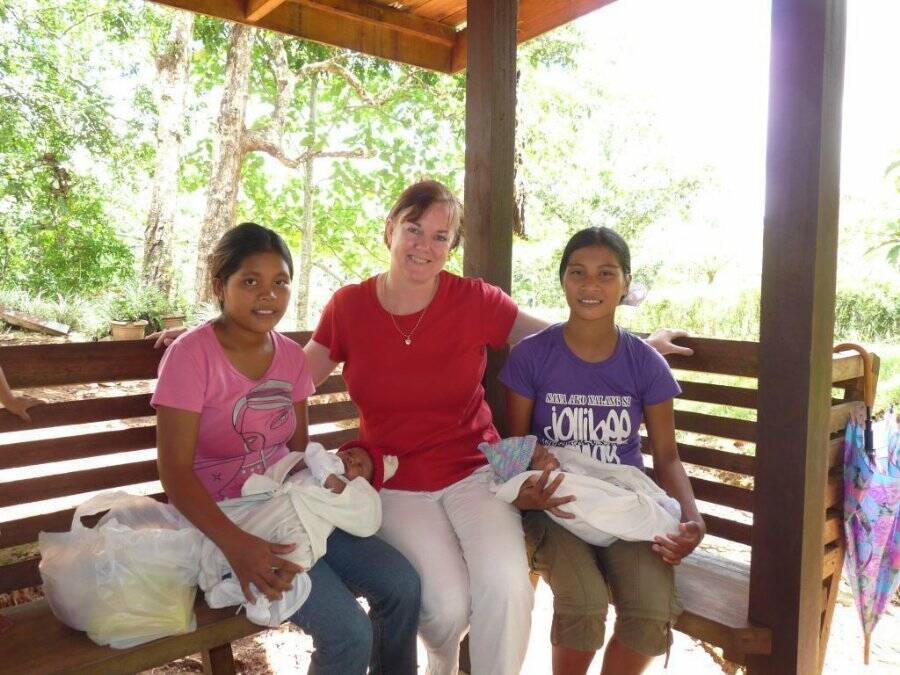 So appreciated, above: Camden Haven missionary Lynne Castelijn in the Philippines with two 'new mums' who are collecting Baby Bundles that include hats and booties knitted here.