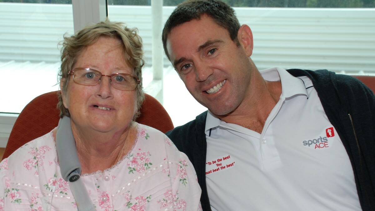 Former rugby league player Brad Fittler takes some time out from a visit to the region to chat with West Haven resident Karen Warburton.