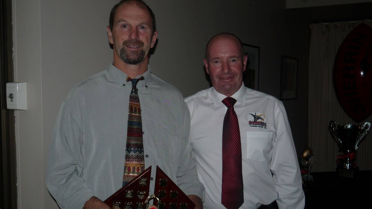 Craig Windsor accepts the Todd and Steph Clarke Clubman Of The Year Trophy from president Todd Clarke.