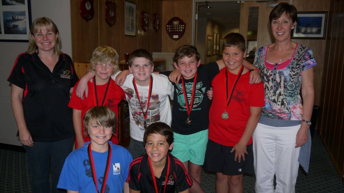 Mel Hunt (coach) and Liz Vanderant (sponsor) congratulate the Under 11 Bombers: Caleb Moss, Ben Coskerie,  Matthew Prendergast,  Brodie Myers and (front) Mitch Hunt and Chaz Wiegold.