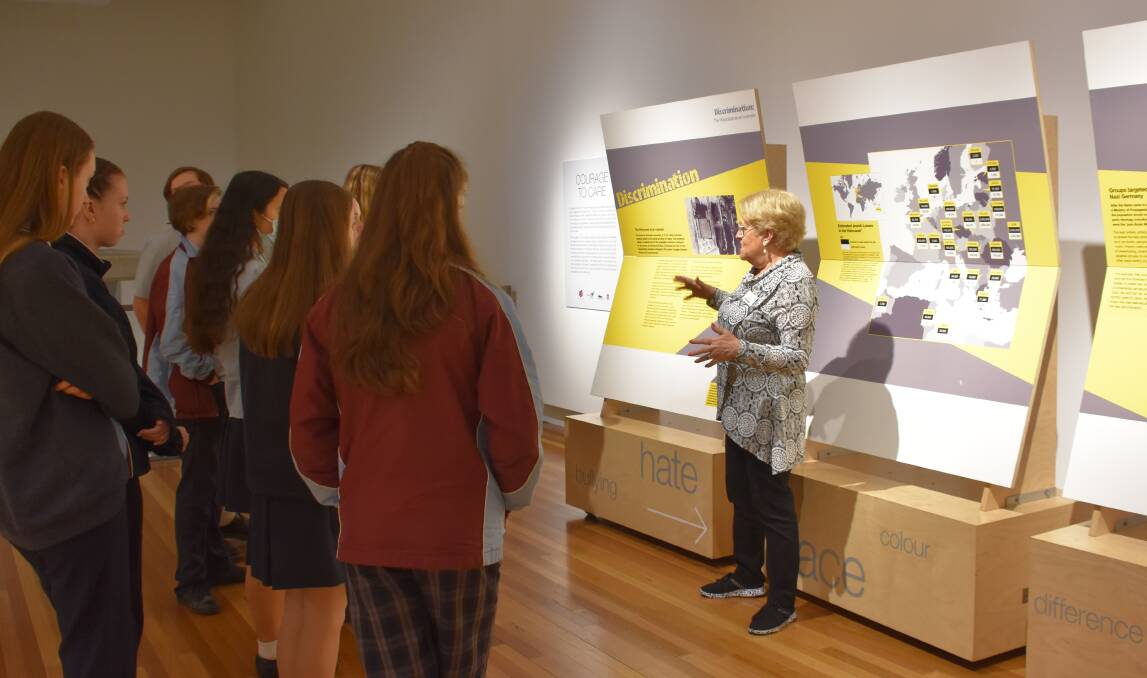 Juliane Michaels spoke to students while guiding them through the exhibit. Picture by Emily Walker