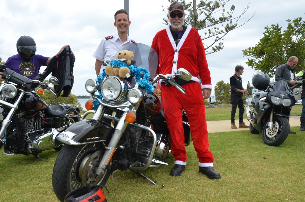 Captain Peter Gott from The Salvation Army with Mid North Coast Chapter of the Harley Owners Group activities officer Chris Jackson at the Salvation Army Toy Run. Bikers travelled from Laurieton Services Club to Westport Park to spread Christmas cheer. Picture by Emily Walker