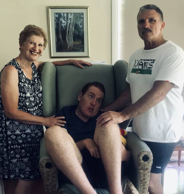 Care: Michael Treacy with his Mum, Penny and carer Geoff Collett from local disability service provider ACES.