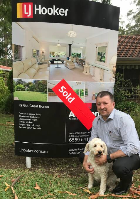 Another one sold: Wayne Heilman from LJ Hooker Laurieton pictured with the office's mascot Manny. 