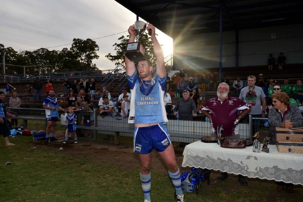 Crowning moment: Kendall's Beau Kettle raising the Hastings League premiership cup on grand final 2017. The Blues are in the hunt for back to back titles with the Long Flat Dragons also pressing their claims.