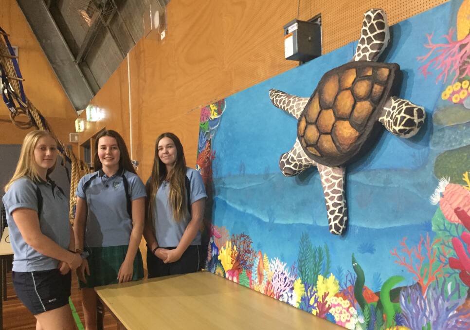More care: Camden Haven High School's year 10 students Isabella Knaack, Maddison Symons and Jaime Swift with their environmentally-inspired contribution.