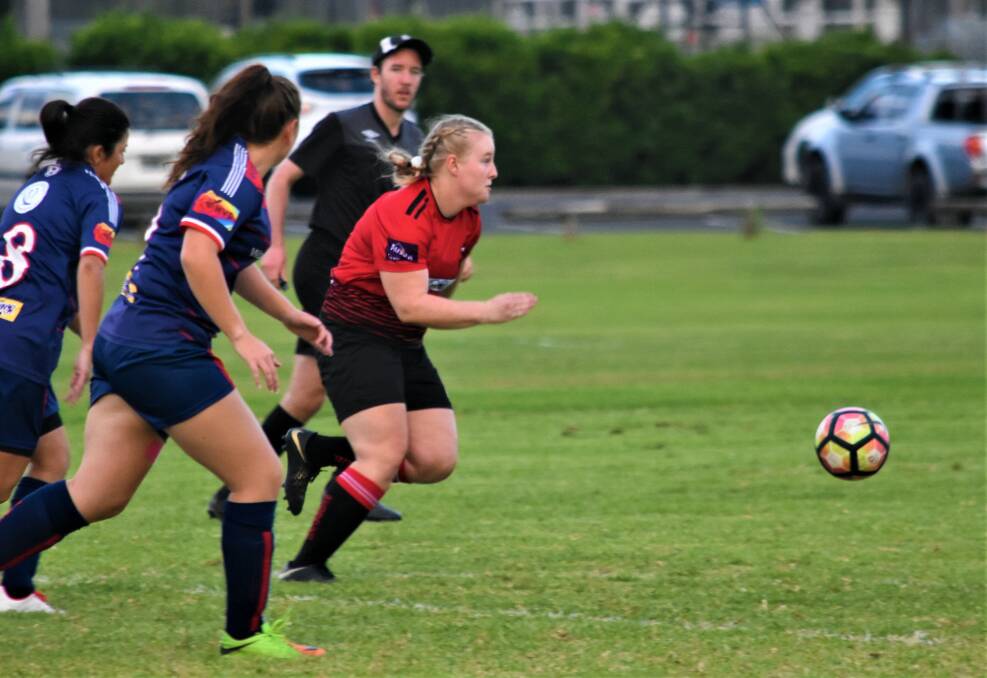 On the run: Camden Haven Redbacks ladies player Wade Bellamy chasing the ball in a recent clash.