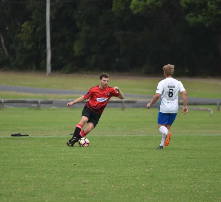On the ball: Camden Haven Redbacks player Harry Forster with ball at his feet against Taree Wildcats.