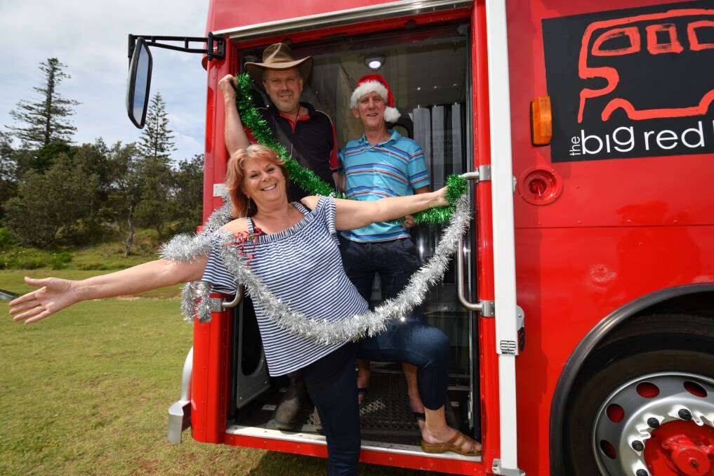 New look: Karen Davies, Ian Rosendahl and Max Davies on The Big Red Bus. Christmas on the Beach is no longer part of our Christmas tradition but the Christmas Breakfast on the Beach will continue. Photo: Oscar Carter