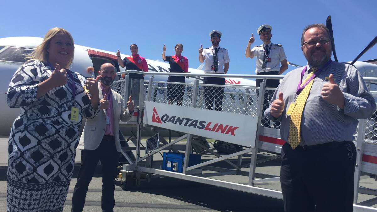 Come away with me: Qantas cabin crew Fiona and Erika with first officer James Courtney and captain Peter Wheeler with mayor Peta Pinson, Qantas' Darren Batty and council's acting general manager Jeffery Sharp.