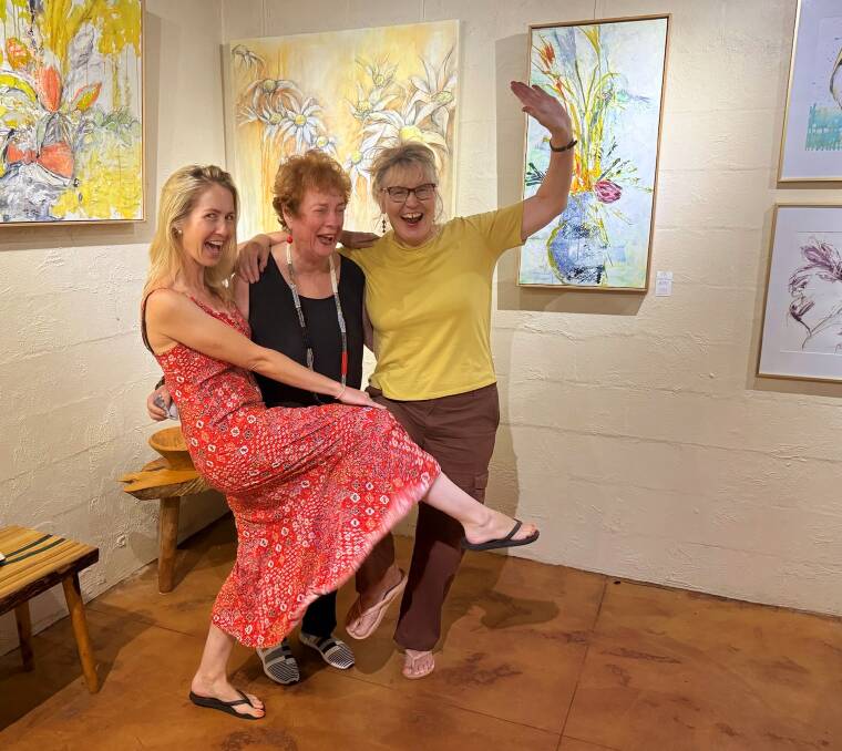 Jane Whitfield, Alita Allison and Yvonne Kiely, whoop it up after hanging their joint works at Long Point Vineyard and Art Gallery. Picture supplied.