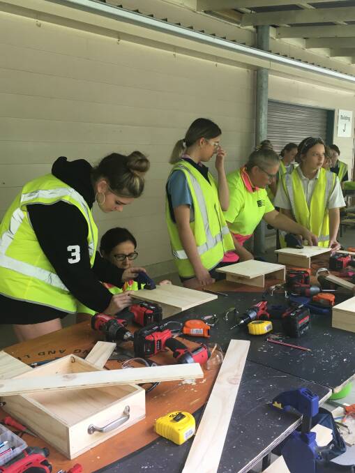 Students engrossed in a construction workshop.